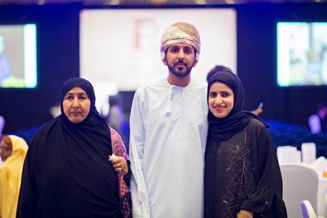 Arab family of three posing at the ACCA event