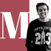 A boy smiling with letter M