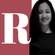 A girl smiling with letter R